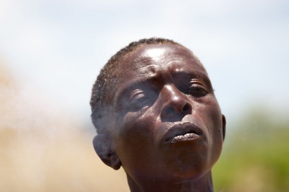 Tonga woman exhaling smoke with eyes closed, near Binga, Zimbabwe